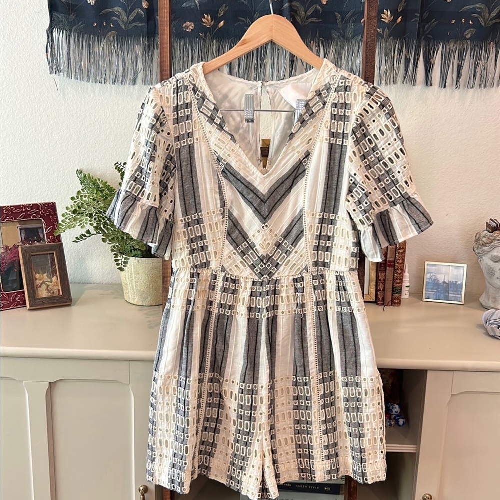 Anthropologie embroidered romper with ruffle sleeve detail.